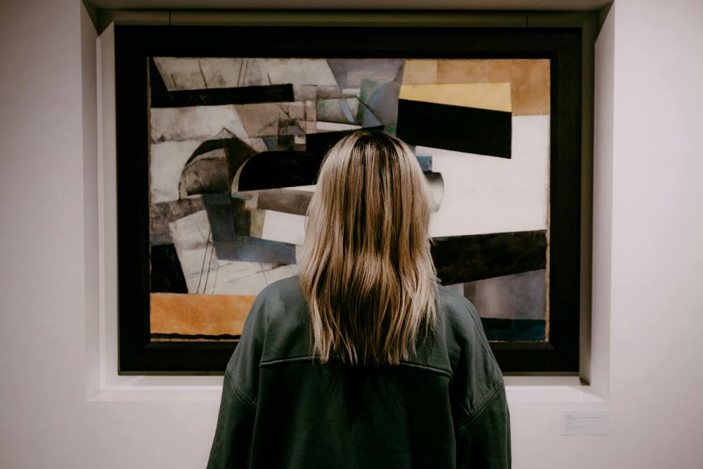 Backview of Woman looking on a Painting